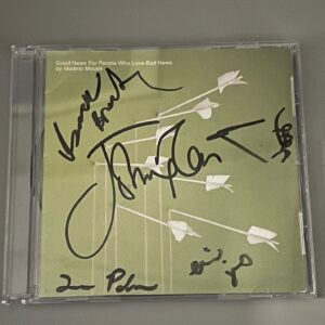 A signed CD cover of "Good News For People Who Love Bad News" by Modest Mouse, featuring a simple green design with white arrows and multiple signatures across the front.